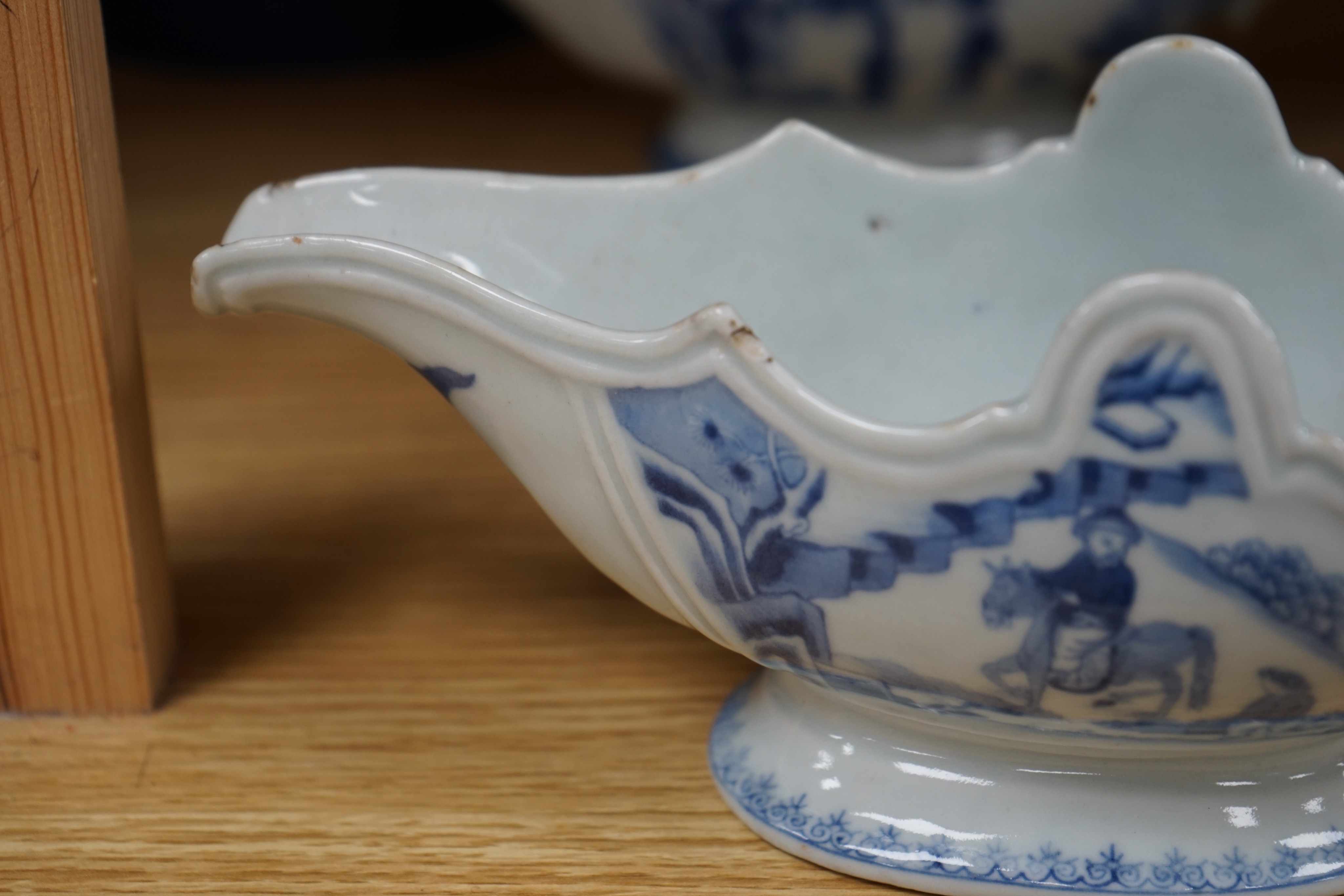 An 18th century Chinese Export blue and white octagonal tureen and cover, decorated with birds and flowers, a pair of similar sauceboats and five plates decorated with urns of flowers